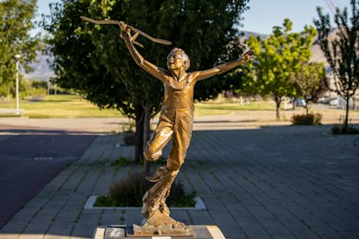 a statue of a person holding a cross