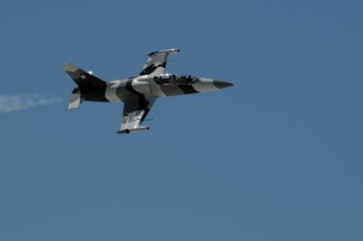 flying gray jet plane during daytime