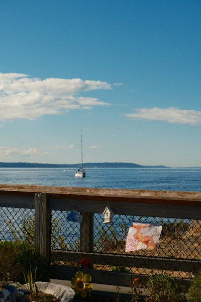 Sailboat on calm blue water under clear sky