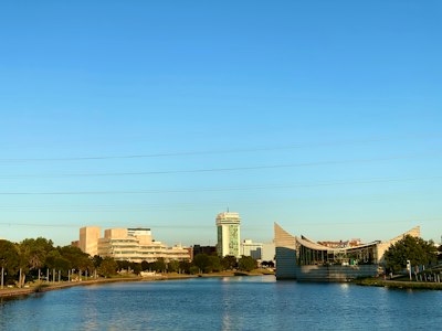 A body of water with buildings in the background