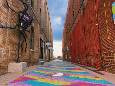 a street with a colorful rug on the side of it